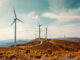 Wind turbines on beautiful sunny summer autumn mountain landsape