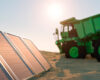 Green energy efficient mining truck concept on a sandy landscape next to a group of solar panels 3d render